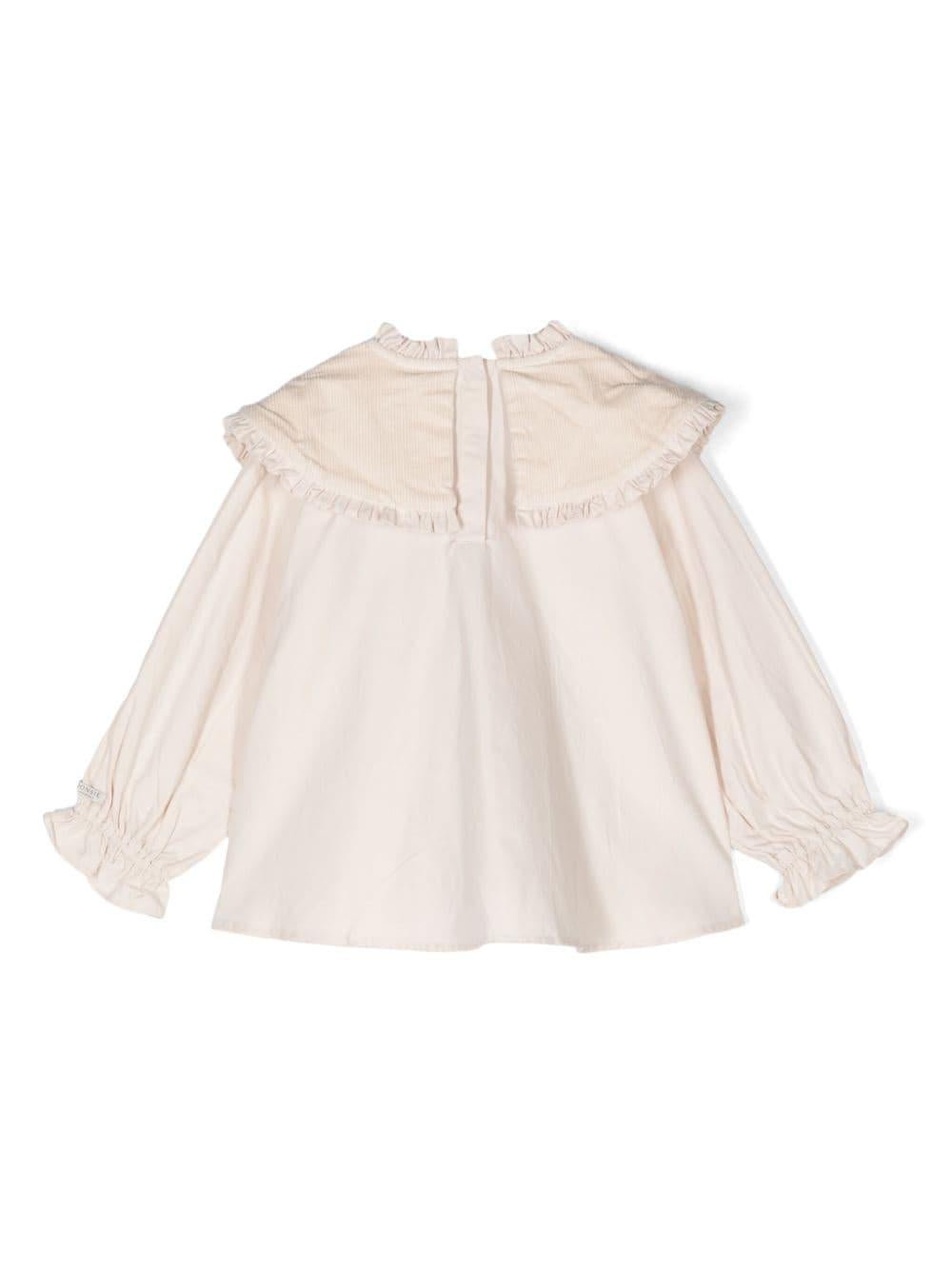 Blusa per bambina Donsje Mellys beige con dettagli ruches e colletto con pettorina - Rubino Kids