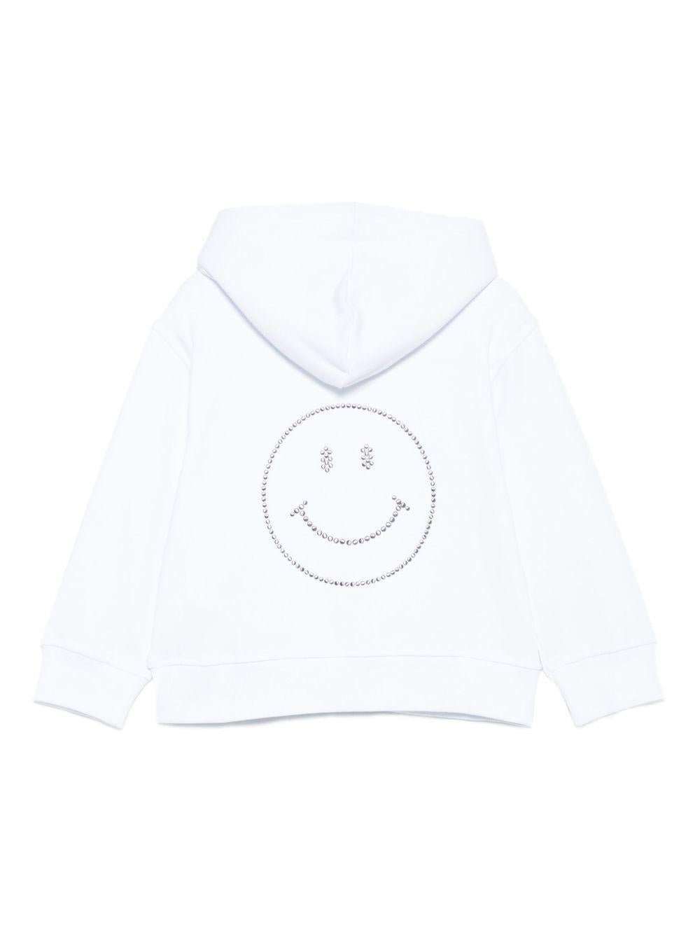 Felpa per bambina Moschino Kids bianco con cappuccio e strass con faccina sorridente - Rubino Kids