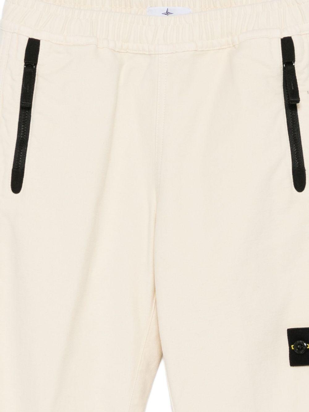 Pantaloni per bambino Stone Island Junior bianchi con applicazione con logo - Rubino Kids