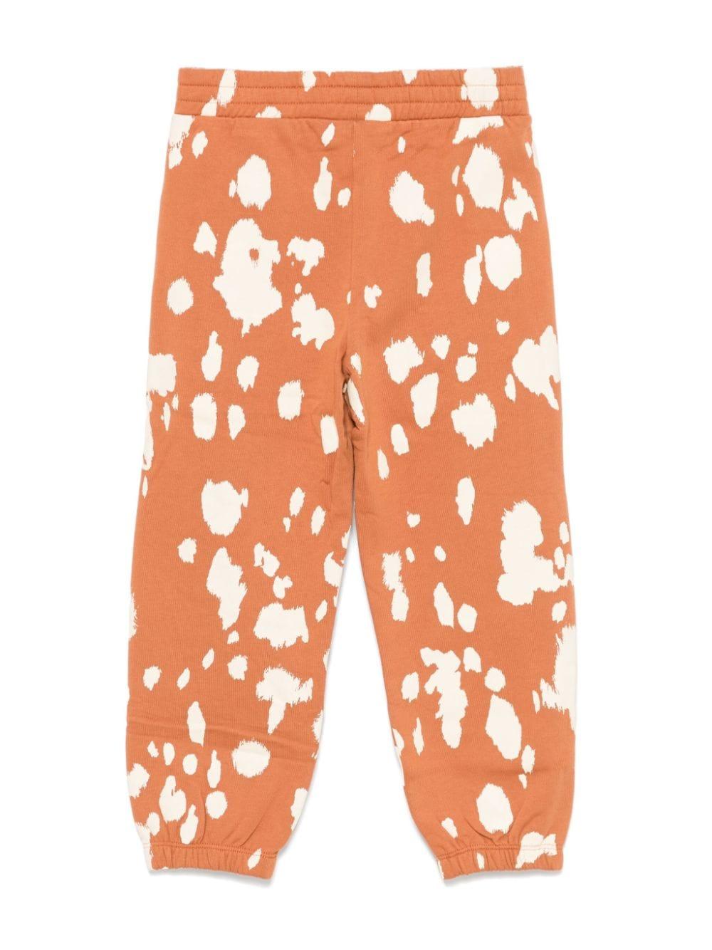 Pantaloni sportivi arancioni per bambina con stampa all over Stella McCartney Kids - Rubino Kids