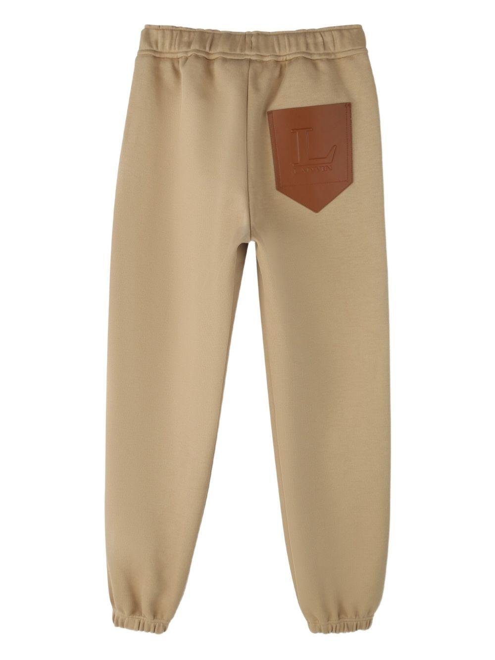 Pantaloni sportivi per bambino Lanvin Enfant beige con applicazione con logo - Rubino Kids