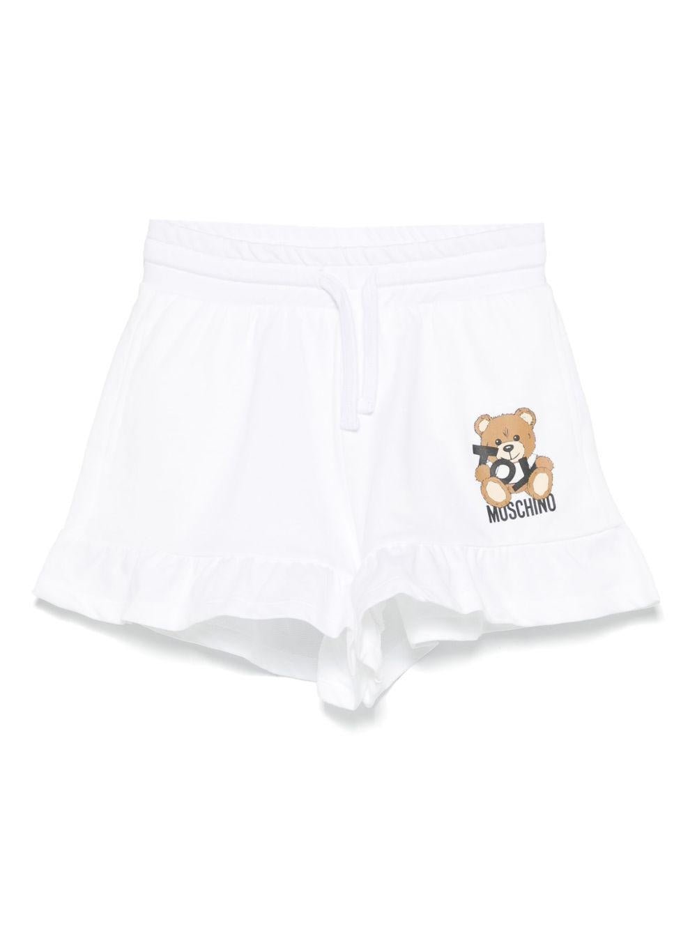 Shorts con stampa Leo Teddy per bambina Moschino Kids bianco con due tasche laterali - Rubino Kids