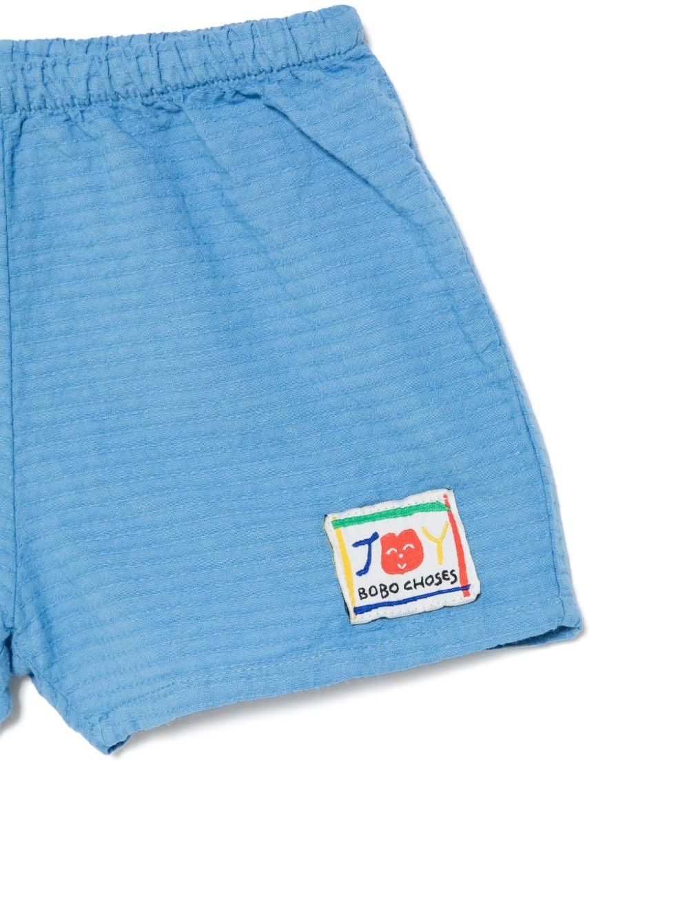 Shorts per neonato Bobo Choses Smilling azzurro con applicazione frontale con logo - Rubino Kids