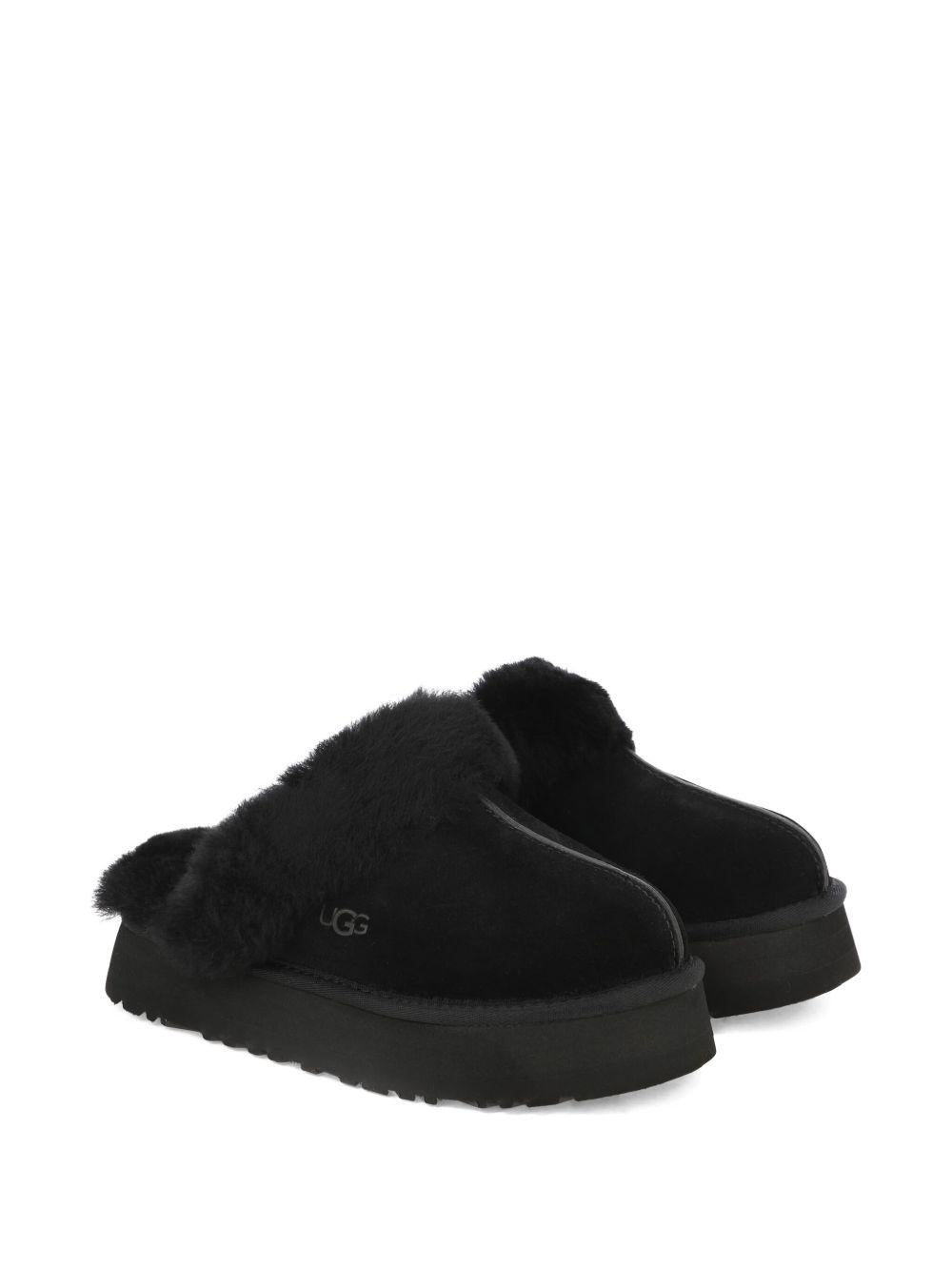 Slippers per bambina UGG Kids Disquette nero con finitura in pelliccia sintetica - Rubino Kids