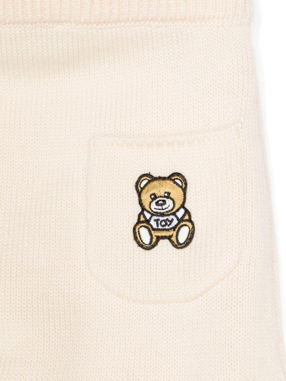 Set cardigan e pantaloni per neonati Moschino Kids beige con design lavorato a maglia MUK04XLHE06 20404 MOSCHINO KIDS 