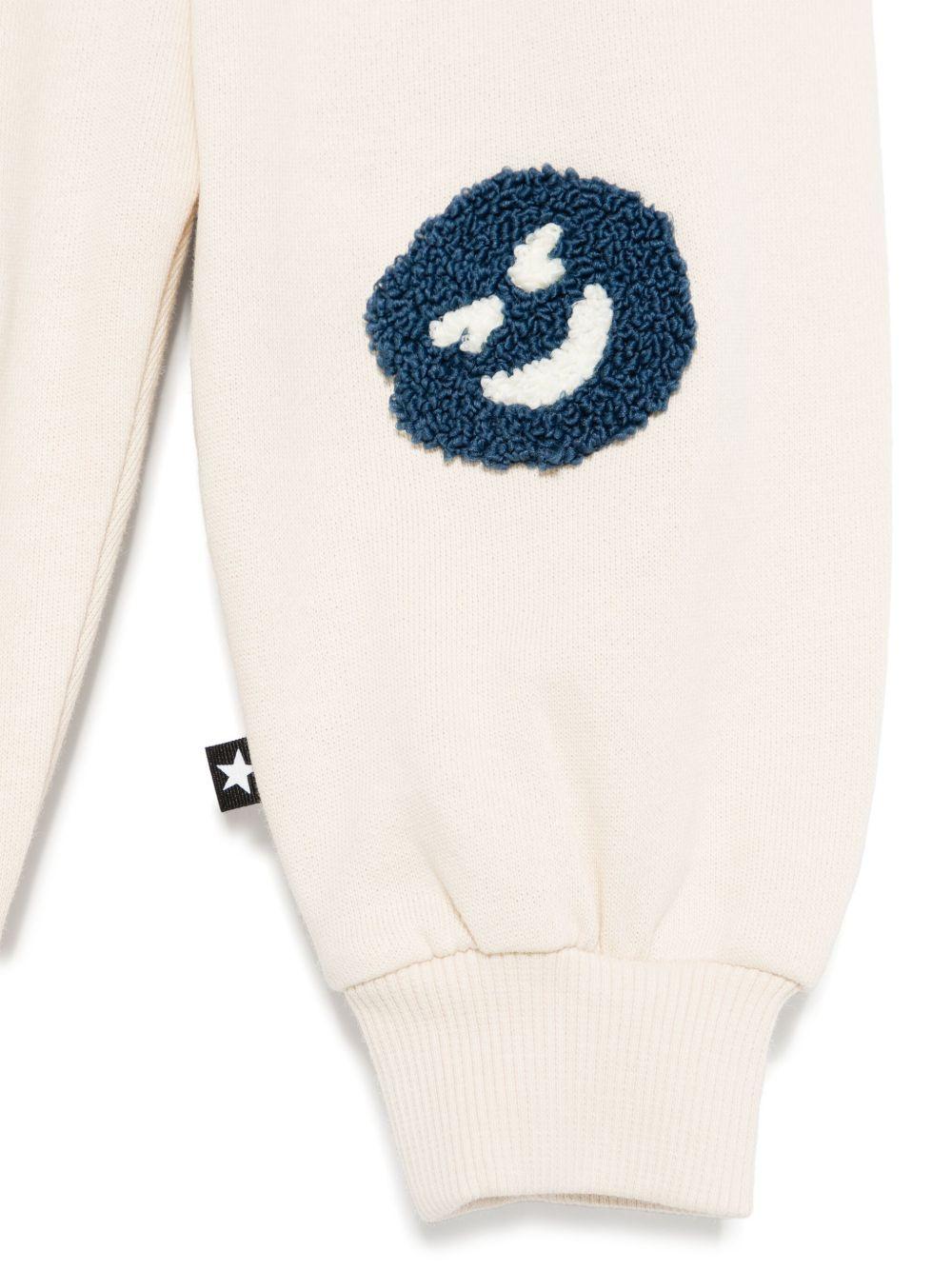 Pantaloni sportivi per neonato Molo Simeon beige con motivo smiley 6S25I206 8894 MOLO 