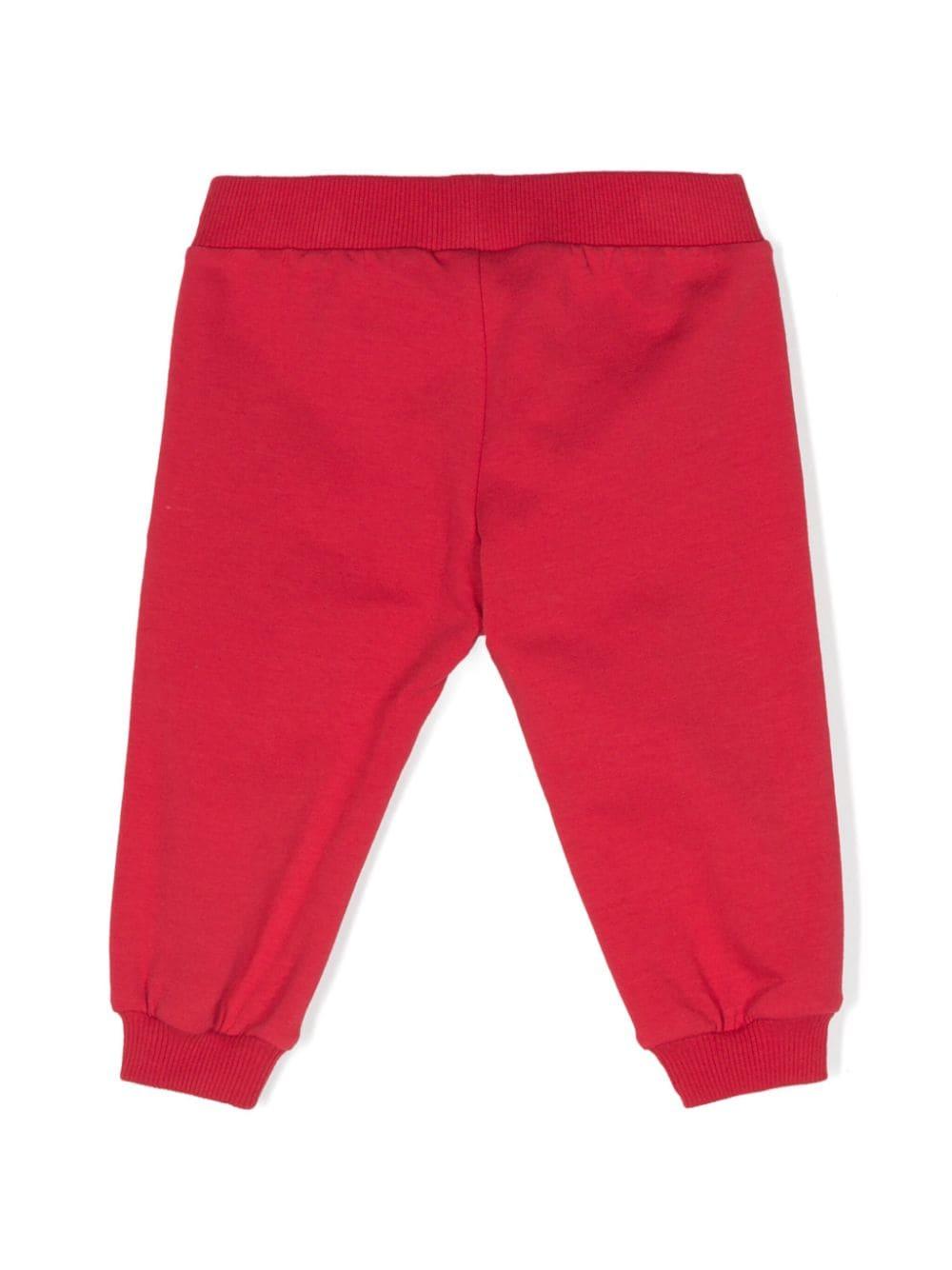 Pantaloni sportivi per neonati Moschino Kids rosso con logo sulla gamba MUP058LDA18 50307 MOSCHINO KIDS 
