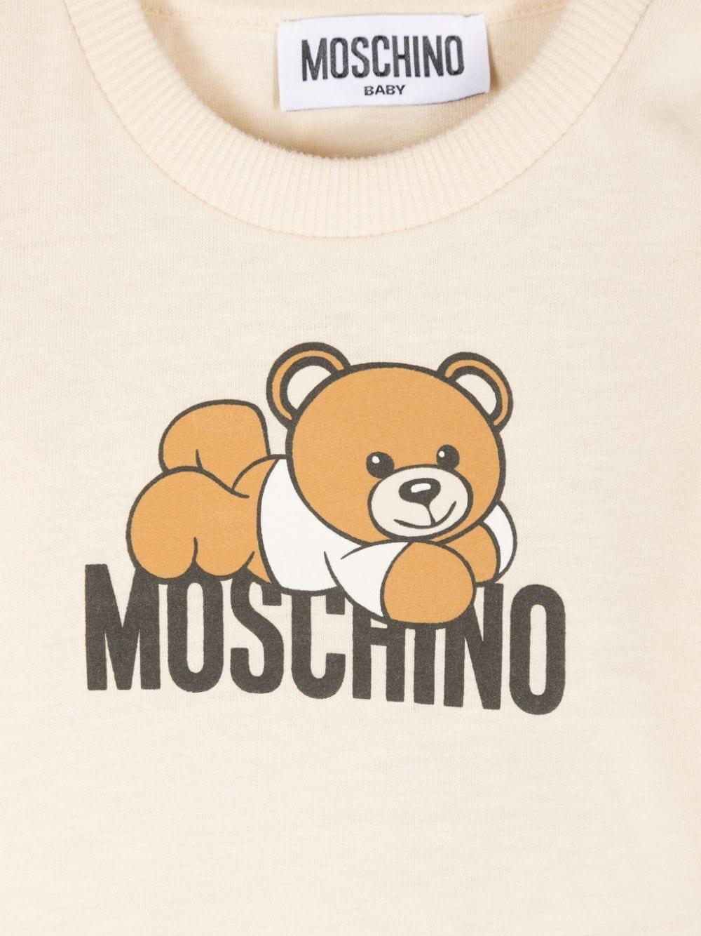 T-shirt per neonati Moschino Kids beige a maniche lunghe con stampa logo MOO00RLAA36 20404 MOSCHINO KIDS 