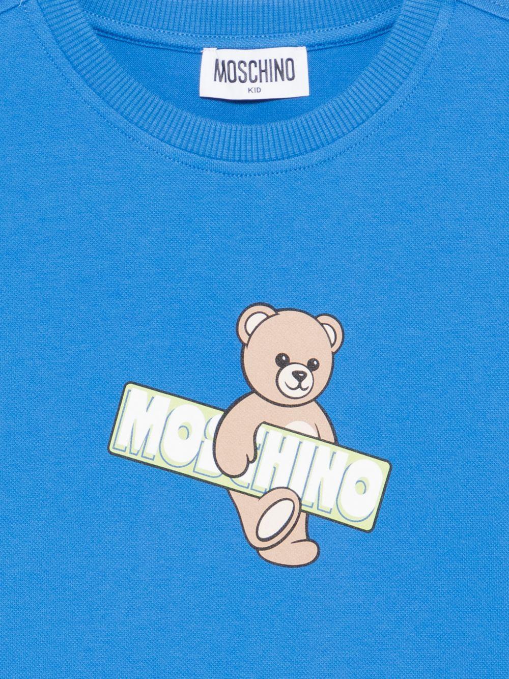 T-shirt per bambini Moschino Kids azzurra con stampa Teddy Bear sul davanti HYM03SLFA07 40630 MOSCHINO KIDS 