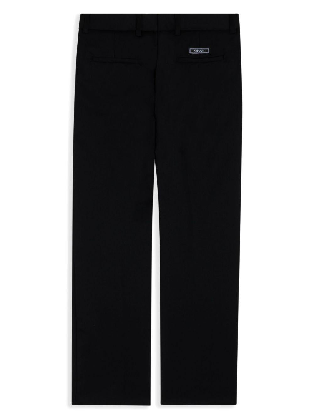 Pantaloni per bambino Versace Kids nero con placca Medusa 10183241A12354 1B000 VERSACE KIDS 