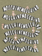 T-shirt per bambini Moschino Kids verde con stampa logo ondulata HXM05GLAA52 30037 MOSCHINO KIDS 
