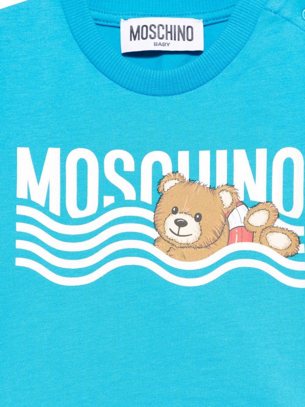 T-shirt per neonato Moschino Kids azzurro con motivo Teddy Bear MUM04DLAA24 41047 MOSCHINO KIDS 