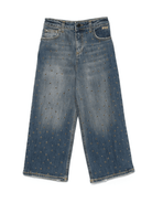 Jeans per bambina MSGm Kids in denim con borchie all - over - Rubino Kids