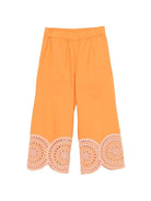 Pantaloni per bambina Stella McCartney Kids arancioni con orlo smerlato - Rubino Kids