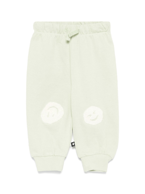 Molo Simeon baby trousers in green with a smiley face motif