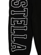 Pantaloni sportivi per bambina Stella McCartney Kids nero con stampa logo sulla gamba - Rubino Kids
