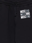 Pantaloni sportivi per bambino Moschino Kids neri con logo sul davanti - Rubino Kids