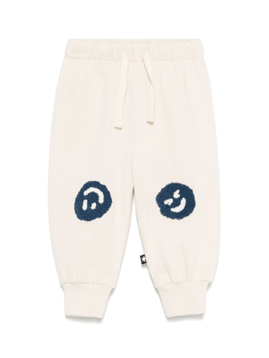 Molo Simeon beige baby sweatpants with smiley face pattern