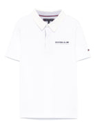 Polo con ricamo per bambino Tommy Hilfiger Junior bianco con spacchi laterali - Rubino Kids