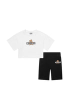 Set t-shirt e shorts per bambina Moschino Kids bianco e nero con motivo Teddy Bear - Rubino Kids