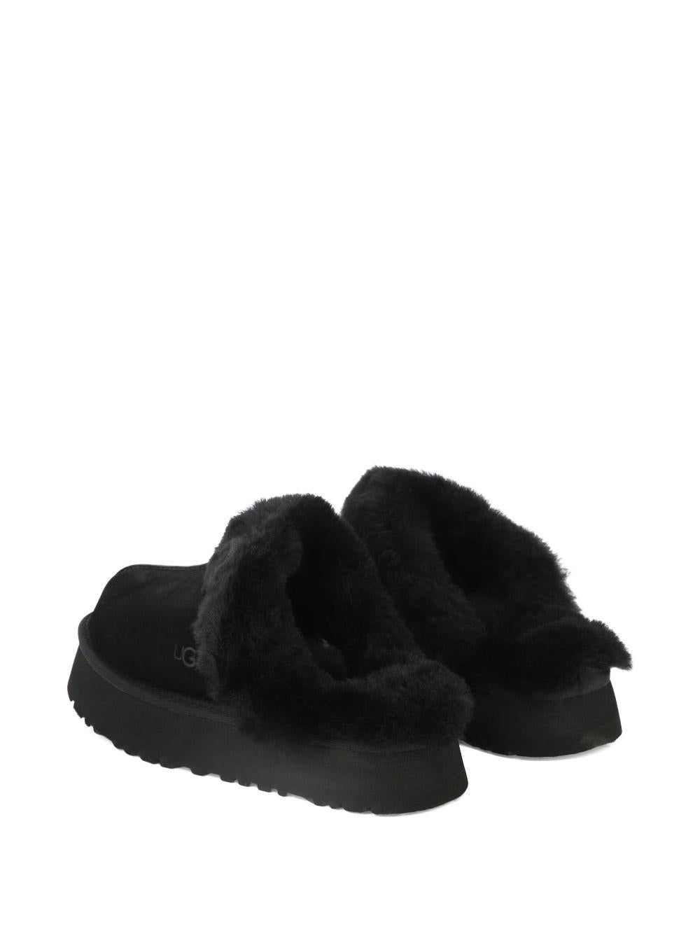 Slippers per bambina UGG Kids Disquette nero con finitura in pelliccia sintetica - Rubino Kids