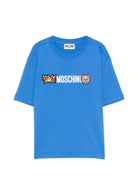 T-shirt per bambini Moschino Kids azzurra con logo sul davanti - Rubino Kids